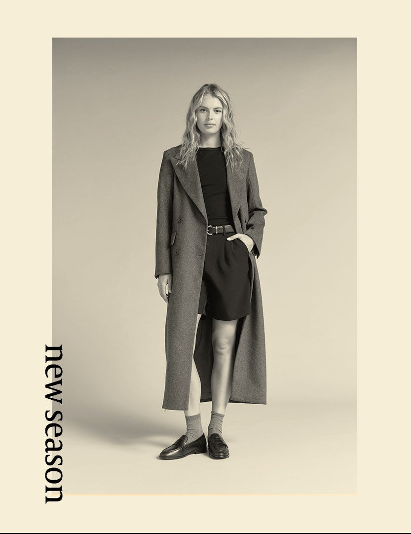 Woman wearing a long gray coat with a black dress on a beige background, with 'new season' text.